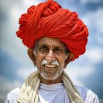 Portrait of an elderly Indian man wearing a vibrant red turban in Rajasthan.